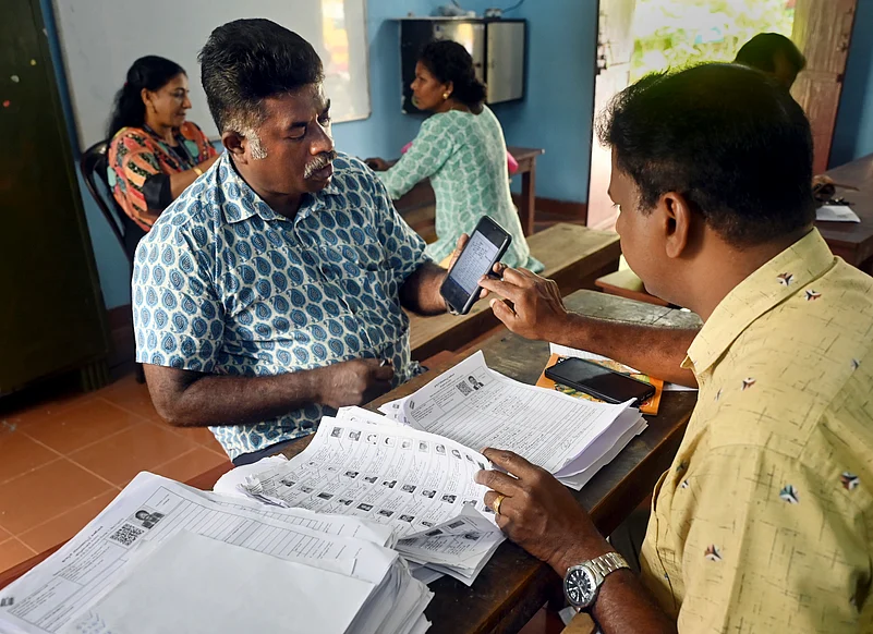 A Booth Level Officer (BLO) interacts with a voter