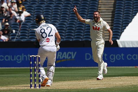 Australia's Michael Neser, right, celenbrates the wicket of England's Jacob Bethell, left, during their Ashes cricket test match in Melbourne.