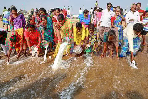 People pour milk as part of rituals to pay tribute to the victims of the 2004 tsunami on the 21st anniversary of the tragedy, at Pattinapakkam beach, in Chennai.