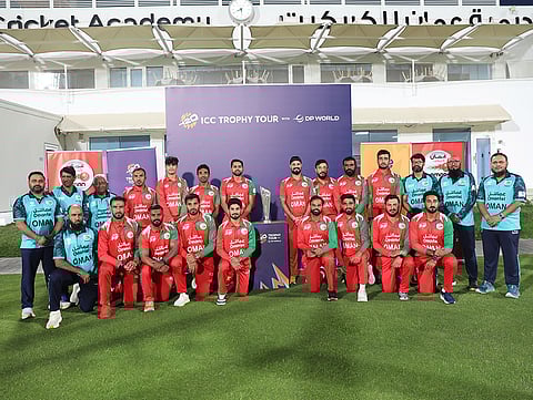 The Oman senior men’s cricket team poses with the ICC Men’s T20 World Cup 2026 trophy at the Oman Cricket Academy during the trophy tour in Oman