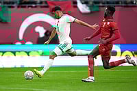 | Photo: AP/Mosa'ab Elshamy : Algeria's Baghdad Bounedjah attempts a shot next to Sudan's Mohamed Saeed Ahmed during the Africa Cup of Nations group E soccer match between Algeria and Sudan in Rabat, Morocco.