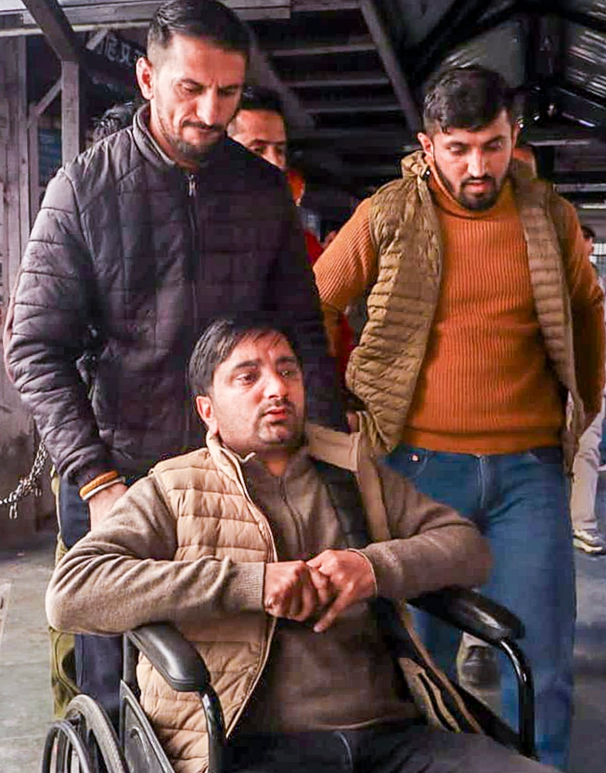 The patient, on a wheelchair, who was allegedly assaulted by a doctor, while lying on a hospital bed, at Indira Gandhi Medical College (IGMC), in Shimla, Monday, Dec. 22, 2025. A video of the incident went viral triggering protests. - PTI