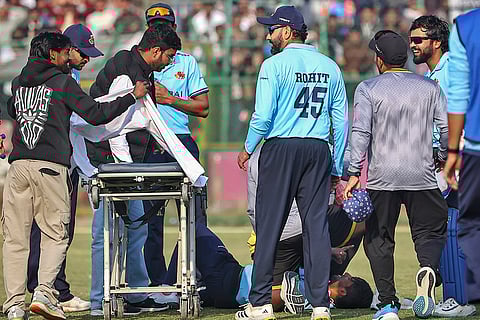 Mumbai’s Angkrish Raghuvanshi being attended by Rohit Sharma and others after an injury during a Vijay Hazare Trophy 2025-26 cricket match between Mumbai and Uttarakhand, at Sawai Mansingh Stadium, in Jaipur, Rajasthan.