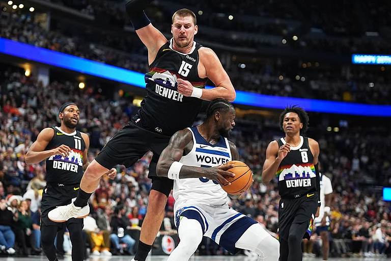 Minnesota Timberwolves center Julius Randle, foreground bottom, takes an elbow to the top of his head from Denver Nuggets center Nikola Jokić, front top, as guards Bruce Brown, back left, and Peyton Watson defend in the second half of an NBA basketball game in Denver. - | Photo: AP/David Zalubowski