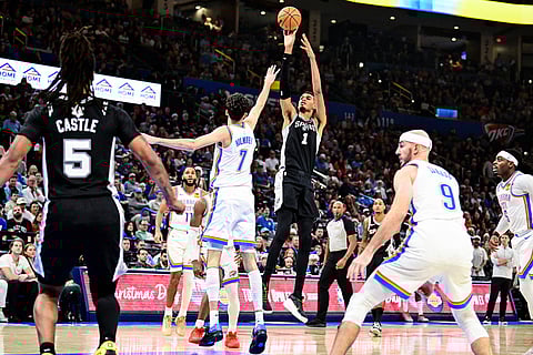 San Antonio Spurs Victor Wembanyama (1) shoots against Oklahoma City Thunder center/forward Chet Holmgren (7) during the first half of an NBA basketball game, in Oklahoma City. 
