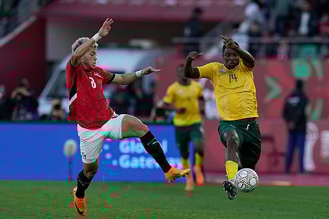 Egypt's Emam Ashour and South Africa's Mbekezeli Mbokazi compete for the ball during the Africa Cup of Nations group B soccer match between Egypt and South Africa in Agadir, Morocco.
