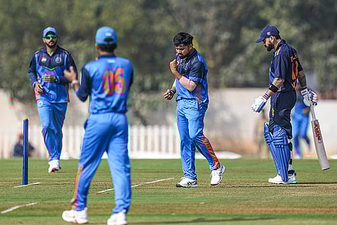Gujarat's Vishal Jayswal, second from right, with teammate celebrates after taking the wicket of Delhi's Virat Kohli during the Vijay Hazare Trophy 2025-26 cricket match between Gujarat and Delhi, at BCCI Centre of Excellence Ground, in Bengaluru.
