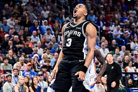 San Antonio Spurs Keldon Johnson (3) celebrates against the Oklahoma City Thunder during the first half of an NBA basketball game, in Oklahoma City.