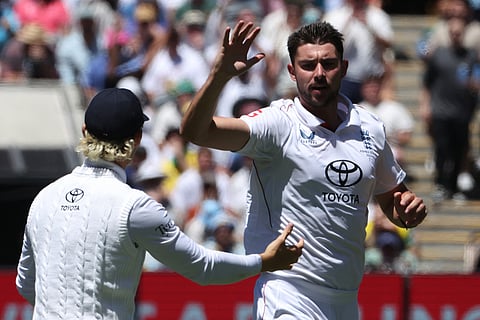 England's Josh Tongue, right, celebrates with teammate Jacob Bethell after the wicket of Australia Usman Khawaja on Day 2 of their Ashes cricket test match in Melbourne.