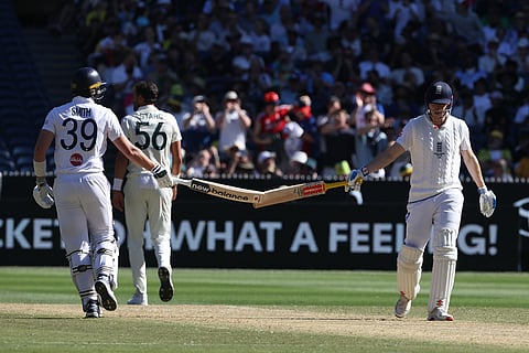 England's Jamie Smith, left and Harry Brook touch bats near the end of their Ashes cricket test match against Australia in Melbourne.
