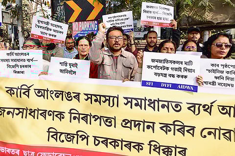People hold banners while protesting over the Karbi Anglong unrest, in Guwahati.