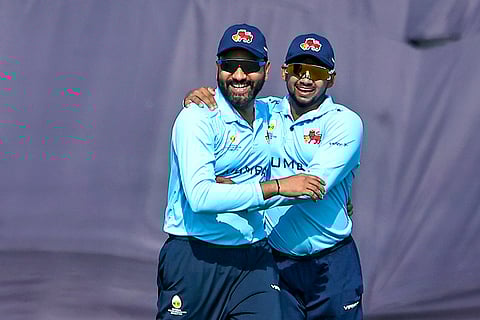 Mumbai’s Rohit Sharma, left, celebrates with Musheer Khan after taking the catch of Uttarakhand’s Kamal Singh during a Vijay Hazare Trophy 2025-26 cricket match between Mumbai and Uttarakhand, at Sawai Mansingh Stadium, in Jaipur, Rajasthan.