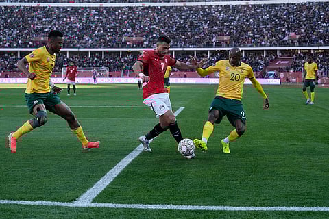 Egypt's Trézéguet is challenged by South Africa's Khuliso Mudau during the Africa Cup of Nations group B soccer match between Egypt and South Africa in Agadir, Morocco.