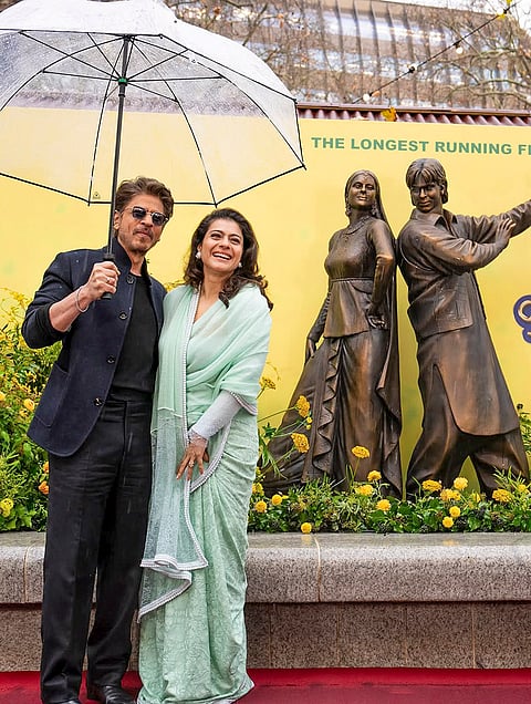 Bollywood actors Shah Rukh Khan and Kajol during unveiling of their 'Dilwale Dulhania Le Jayenge' sculpture at Leicester Square, in London, Thursday, Dec. 4, 2025.