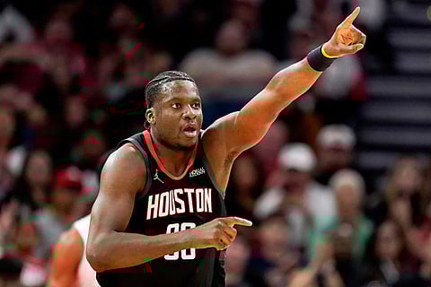 Houston Rockets center Clint Capela reacts after making a basket against the Cleveland Cavaliers during the second half of an NBA basketball game in Houston.