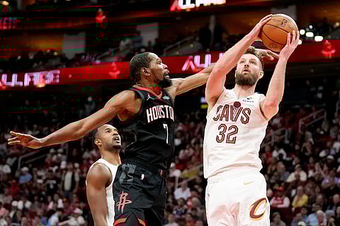 Cleveland Cavaliers forward Dean Wade (32) drives to the basket past Houston Rockets forward Kevin Durant (7) during the second half of an NBA basketball in Houston.