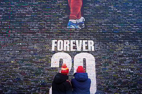 Fans at The "Forever 20" wall, a tribute mural in memory of Diogo Jota, ahead of the Premier League match at Anfield, Liverpool, England.