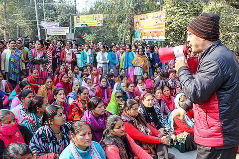People protest as a survey team arrives following a Supreme Court order probing the leasing of government forest land, in Rishikesh.