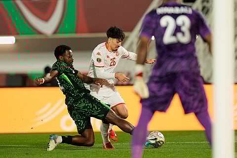 Nigeria's Bright Osayi-Samuel, left, defends against Tunisia's Sebastian Tounekti during the Africa Cup of Nations group C soccer match between Nigeria and Tunisia in Fez, Morocco.