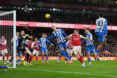 Brighton's Georginio Rutter, right, scores an own goal during the English Premier League soccer match between Arsenal and Brighton and Hove Albion in London.