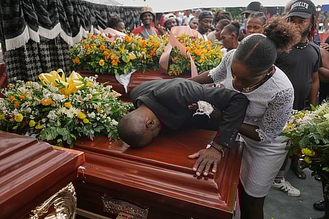 Relatives of Rosiclaire Lenchise mourn during a funeral of victims killed by a landslide triggered by Hurricane Melissa, Nov. 15, 2025, in Petit Goave, Haiti.