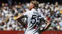 | Photo: AP/Hamish Blair : England's Ben Stokes pauses before bowling a delivery to Australia on Day 2 of their Ashes cricket test match in Melbourne, Saturday, Dec. 27, 2025. 