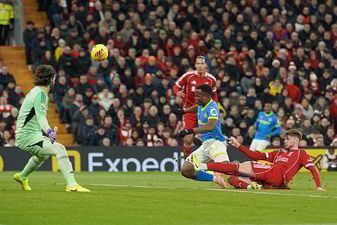 Liverpool's Conor Bradley, right, tries to block a shot from Wolverhampton Wanderers' Jhon Arias, center, during the English Premier League soccer match between Liverpool and Wolverhampton Wanderers in Liverpool.