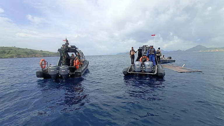 In this photo released by the Indonesian National Search and Rescue Agency (BASARNAS) on Saturday, Dec. 27, 2025, rescuers examine the waters where a debris believed to be from a tour boat that sank was found, near Padar Island within Komodo National Park, Indonesia. - | Photo: AP/BASARNAS