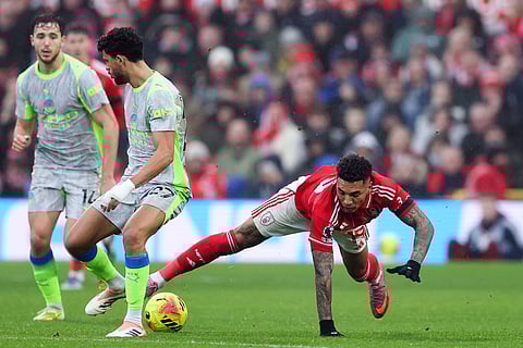 Manchester City's Matheus Nunes and Nottingham Forest's Igor Jesus, right, battle for the ball during the Premier League match between Nottingham Forest and Manchester City, in Nottingham, England.