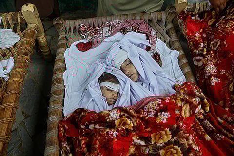 Bodies of children killed in flash flooding lie at a home Aug. 16, 2025, near Pir Baba, Buner district, Pakistan.