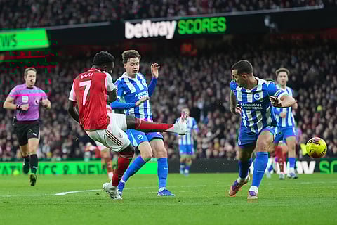 Arsenal's Bukayo Saka has a shot on goal during the English Premier League soccer match between Arsenal and Brighton and Hove Albion in London.