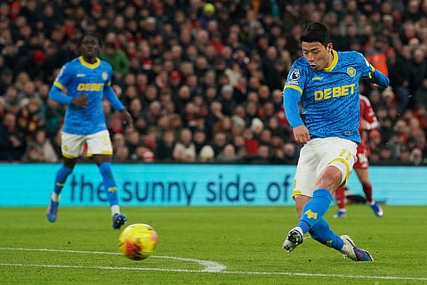 Wolverhampton Wanderers' Hwang Hee-chan kicks the ball during the English Premier League soccer match between Liverpool and Wolverhampton Wanderers in Liverpool.