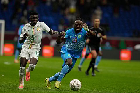 Senegal's Lamine Camara and DR Congo's Fiston Mayele compete for the ball during the Africa Cup of Nations group D soccer match between Senegal and DR Congo in Tangier, Morocco.