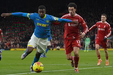 Wolverhampton Wanderers' Yerson Mosquera, left, duels for the ball with Liverpool's Curtis Jones during the English Premier League soccer match between Liverpool and Wolverhampton Wanderers in Liverpool.