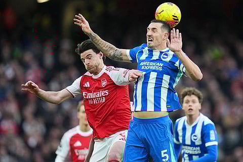 Arsenal's Declan Rice and Brighton's Lewis Dunk challenge for the ball during the English Premier League soccer match between Arsenal and Brighton and Hove Albion in London.