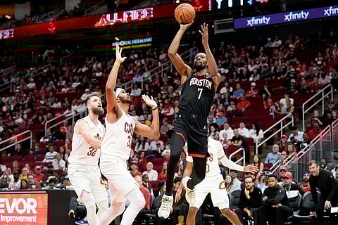 Houston Rockets forward Kevin Durant (7) shoots as Cleveland Cavaliers center Jarrett Allen, left, defends during the first half of an NBA basketball game in Houston.