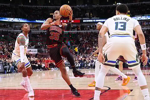 Chicago Bulls forward Isaac Okoro (35) drives to the basket against Milwaukee Bucks guard Kevin Porter Jr., left, during the second half of an NBA basketball game in Chicago.