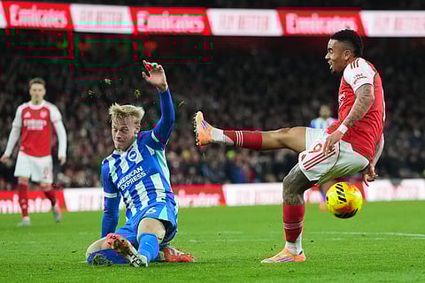 Arsenal's Gabriel Jesus and Brighton's Jan Paul van Hecke challenge for the ball during the English Premier League soccer match between Arsenal and Brighton and Hove Albion in London.