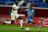 | Photo: AP/Themba Hadebe : DR Congo's Meschack Elia and Senegal's Kalidou Koulibaly compete for the ball during the Africa Cup of Nations group D soccer match between Senegal and DR Congo in Tangier, Morocco.
