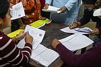 Photo: PTI : People gather at a school during a hearing under the Special Intensive Revision (SIR) of electoral rolls, in Kolkata, West Bengal.
