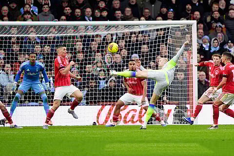 Manchester City's Erling Haaland shoots towards goal during the Premier League match between Nottingham Forest and Manchester City, in Nottingham, England.