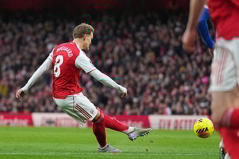 Arsenal's Martin Odegaard scores the opening goal during the English Premier League soccer match between Arsenal and Brighton and Hove Albion in London.