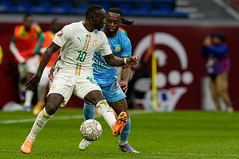 Senegal's Sadio Mane is challenged by DR Congo's Aaron Wan-Bissaka during the Africa Cup of Nations group D soccer match between Senegal and DR Congo in Tangier, Morocco.