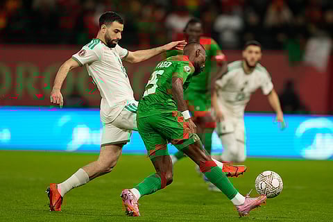 Algeria's Rafik Belghali challenges Burkina Faso's Steeve Yago during the Africa Cup of Nations group E soccer match between Algeria and Burkina Faso in Rabat, Morocco.