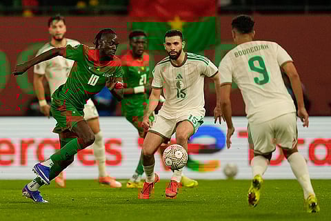 Burkina Faso's Bertrand Traore is challenged by Algeria's Rayan Ait Nouri during the Africa Cup of Nations group E soccer match between Algeria and Burkina Faso in Rabat, Morocco.