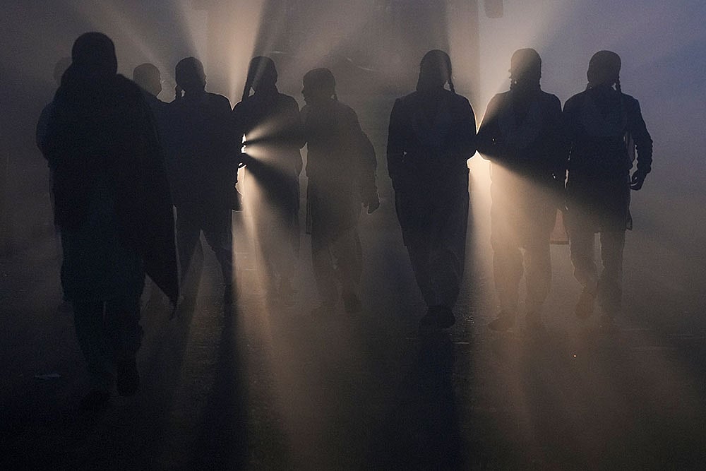 Students walk along a road on their way to school amid dense fog on a winter morning, in New Delhi. - | Photo: PTI/Ravi Choudhary