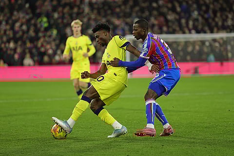Crystal Palace's Tyrick Mitchell, right, and Tottenham's Mohammed Kudus challenge for the ball during the English Premier League soccer match between Crystal Palace and Tottenham Hotspur in London.