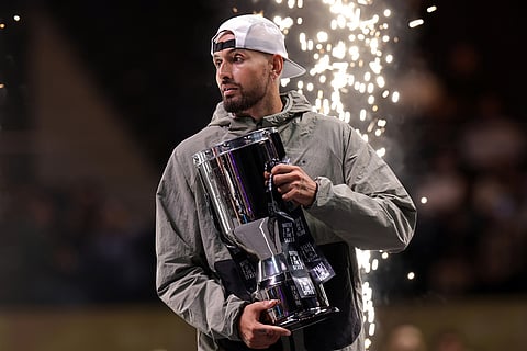 Nick Kyrgios poses with the trophy after winning the Battle of the Sexes match against Aryna Sabalenka, in Dubai, United Arab Emirates.