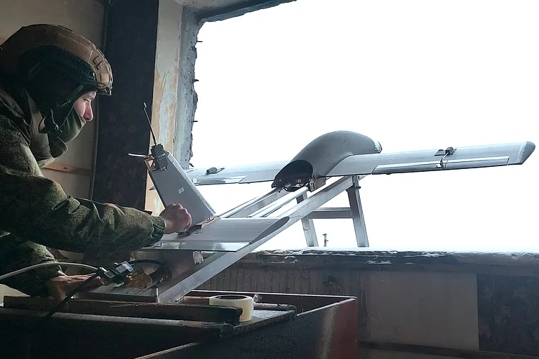 In this image made from video provided by Russian Defense Ministry Press Service on Saturday, Dec. 27, 2025, a Russia Army soldier launches a drone for an action in an undisclosed location in Ukraine. - (Russian Defense Ministry Press Service via AP)