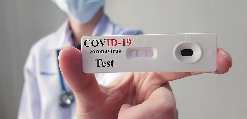 A doctor holding Covid-19 Antigen Test